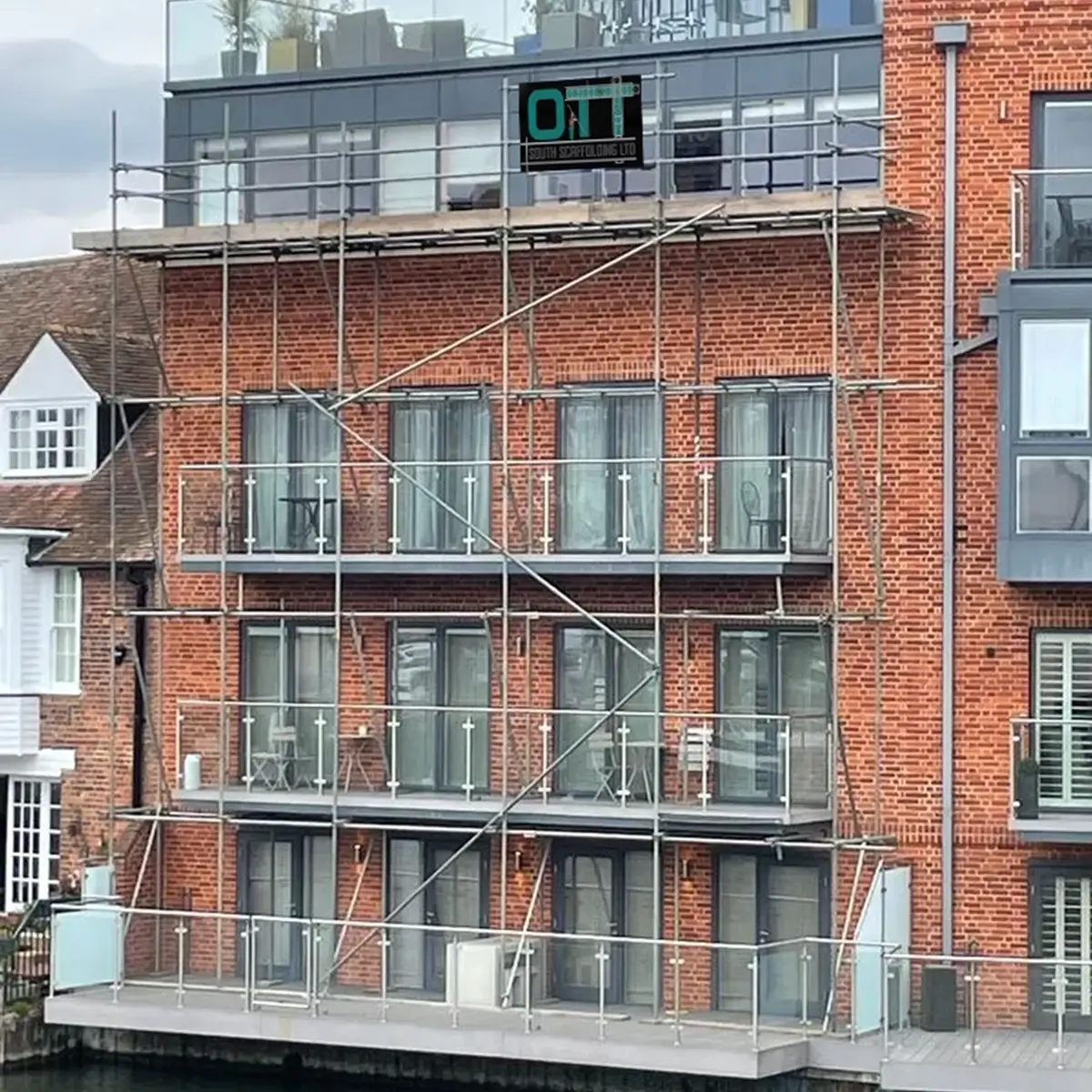 a brick building with scaffolding around the windows