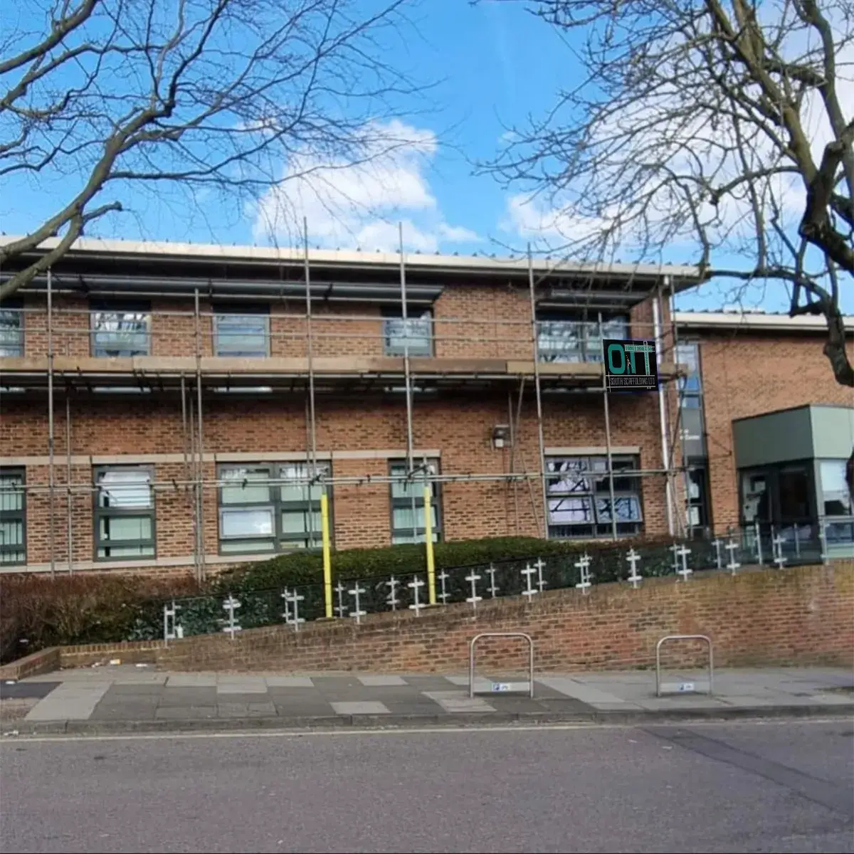 a brick building with scaffolding around the windows