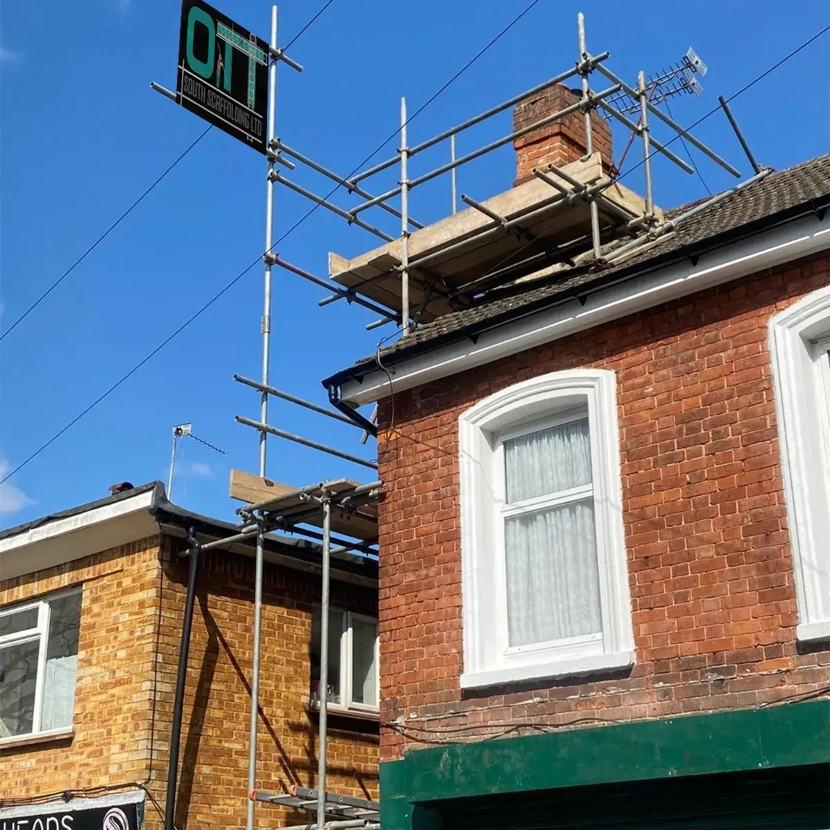 a brick building with scaffolding around the windows