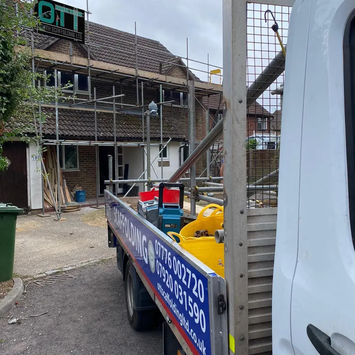 a white truck parked in front of a building under construction