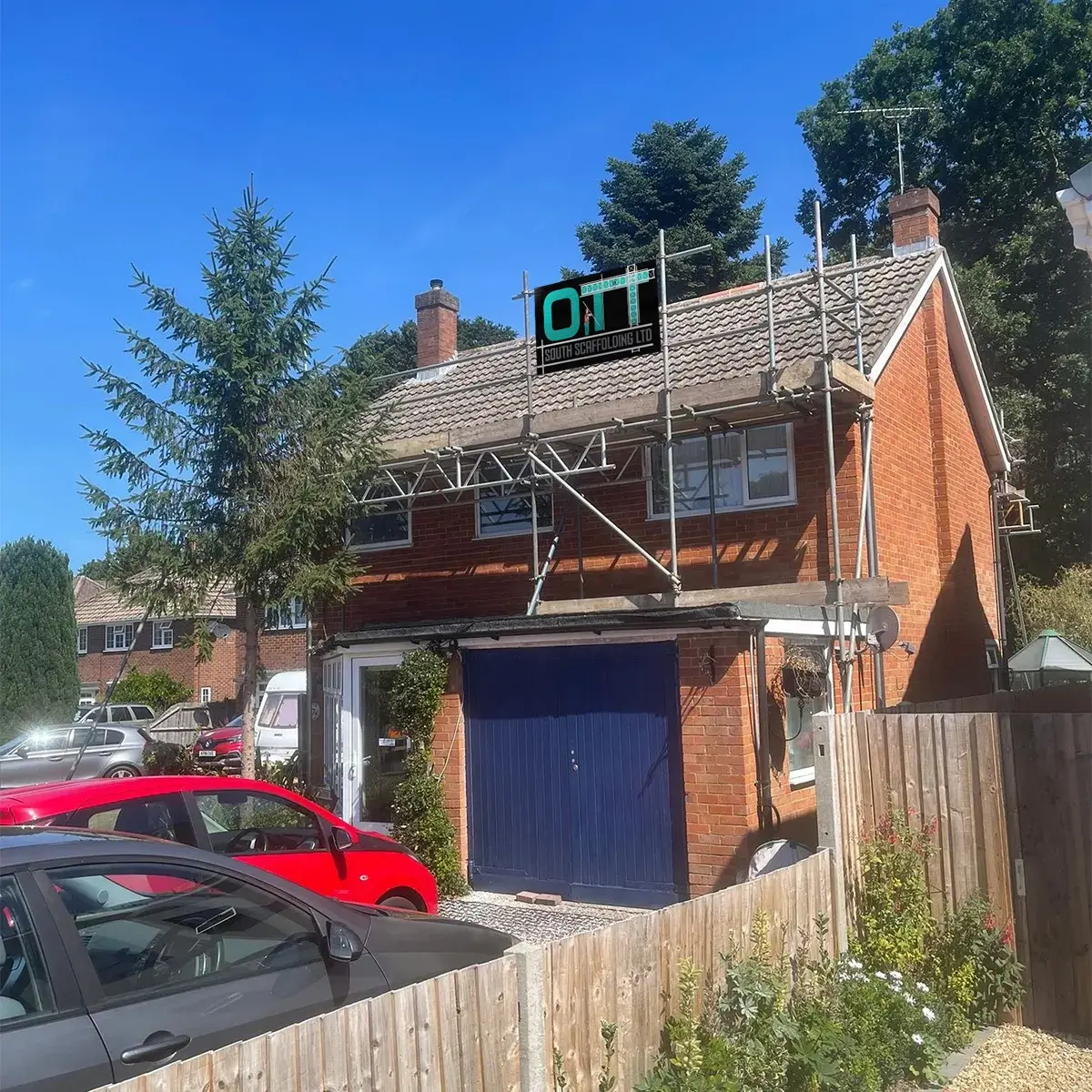 a red car is parked in front of a house
